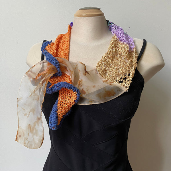 A unique scarf made from eco-dyed silk organza and a variety of threads, yarns and hand-painted silk strips. Art to wear.